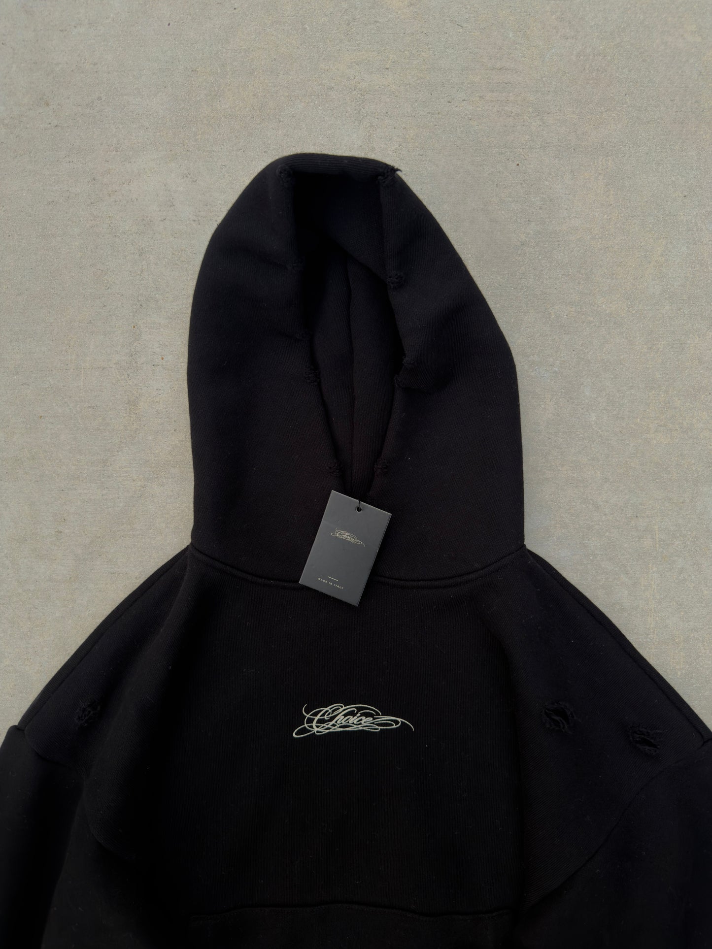 CHOICE Hoodie in black — front with hang tag, hood and distressing detail
